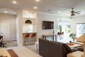 View of the wet bar and into the kitchen and dining from the living room