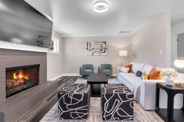 Marvel at the living room view highlighted by wing chairs, ottoman and a sofa.