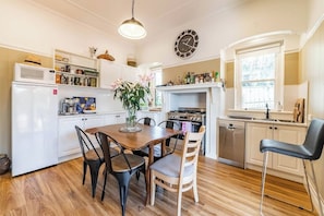 Dining room and full kitchen with fridge, oven, dishwasher and more.