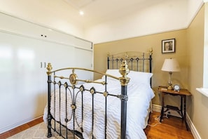 Bedroom one - complete with a charming and comfortable bed, ample storage and gorgeous furniture.