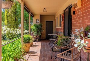 The back porch with seating overlooking the large backyard. The perfect spot to enjoy a coffee or wine.