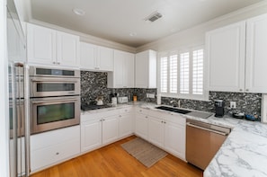 This kitchen has modern appliances a coffeemaker and kitchen essentials.