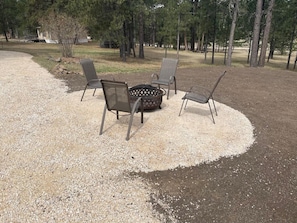 Inviting home boasting a cozy fire pit, perfect for evenings of warmth and camaraderie under the stars.
