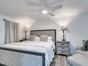 The large, King bed has cozy white sheets and down alternative pillows for your comfort!