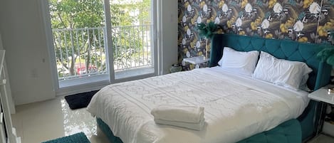 Main bedroom with balcony, bathroom, fireplace and walk in closet.