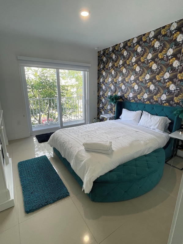 Main bedroom with balcony, bathroom, fireplace and walk in closet.