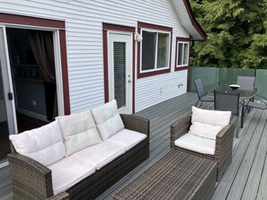 Spacious outdoor living area with gas bbq, eating and lounging area.