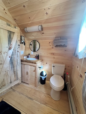 Bathroom with small standup shower.