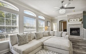 Living room with fire place, big picture windows.