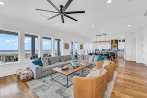 Stunning living room: large TV, gas fireplace, and seating for over 10 people.
