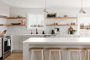 The beautiful kitchen is open-concept with the dining and main floor living space.