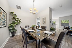 Modern dining table that sits 6 with full tableware and silverware included.