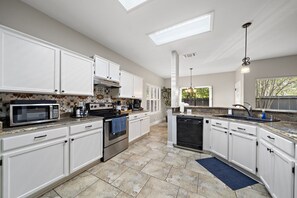 Fully equipped kitchen with high quality granite countertops.