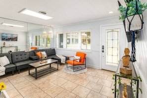 Cozy living room with modern furniture, natural light and elegant decoration. A perfect space to relax and enjoy your stay.