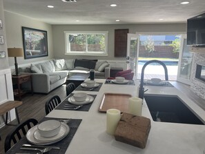 The open concept design creates easy flow from the kitchen to the pool