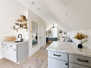 Open concept layout with small balcony.