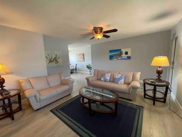 Large living room with sofa and loveseat. Large 55" Smart TV with cable. 