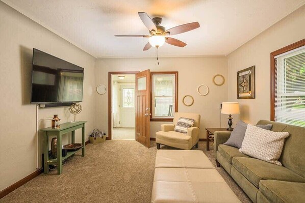 Spacious living room with 65" smart TV and surround sound.  Attached 3 season sun porch.