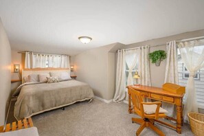 Bedroom 2 with King bed and desk.
