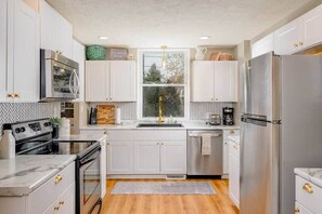 Beautifully remodeled, fully equipped kitchen with stainless appliances.