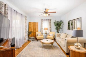 Living room with plenty of seating and 55" smart TV