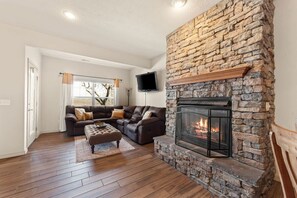 A cozy fireplace in the downstairs living room