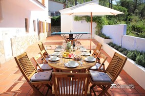 Large pine dining table and chairs for family outdoor dining.
