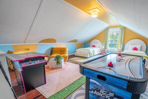 Welcome to the Twin Suite, an ideal retreat for kids, equipped with 2 player Pac-Man arcade and air hockey table for endless fun.