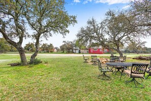 Outdoor amenities including a firepit and outdoor dining