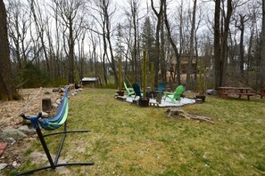 The backyard offers so many choices! Relax by the wood-burning fire pit or hang out in the hammock! There are also picnic tables for al fresco dining!