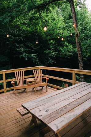 Our raised deck with festival lights, views, and picnic table for country nights