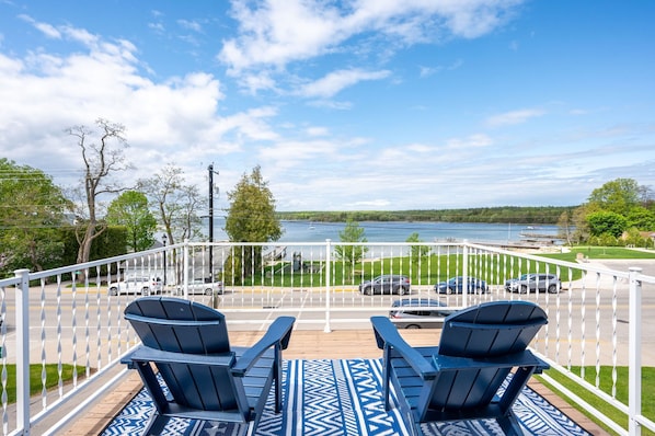Located just off of the upstairs primary bedroom, the upper deck offers stunning water views.