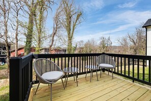 Outdoor deck with small coffee tables and two chairs for lounging, coffee, cocktails, and star-gazing