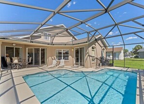 Splash and relax in a screened pool area with a sunny lounging space