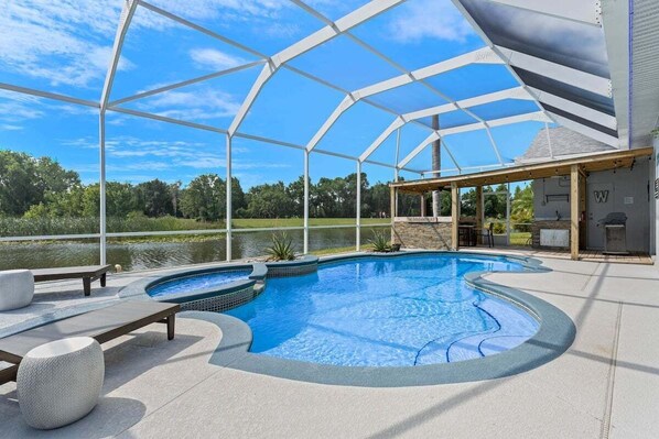 Relax in your private screened-in pool and spa with stunning views of the lake and golf course—your perfect Florida oasis.