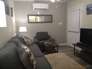 Cozy Living Room with Smart TV Entertainment and Remote Controlled AC