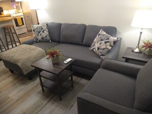 Comfortable Living Space with Fabric Armchair and Sectional Sleeper-Sofa