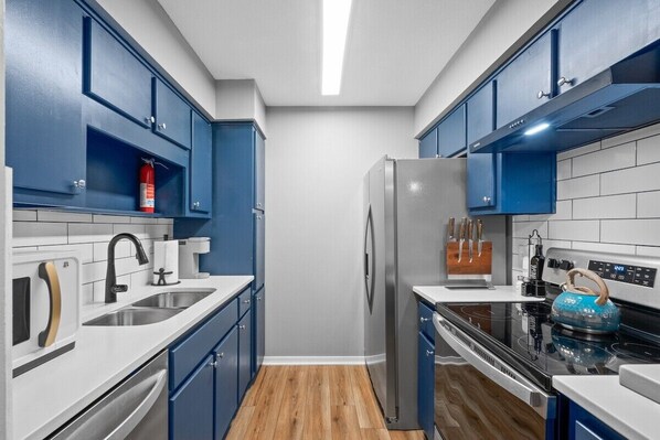 All new, blue kitchen fully loaded with all the amenities.