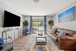 Spacious living area with patio and large smart TV