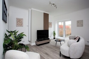 Welcome to your urban oasis in the heart of the city! Step into the spacious living room where modern elegance meets comfort!!