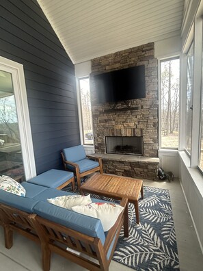 Screened in back porch with fireplace 