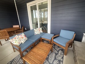 Screened in back porch seating near fireplace