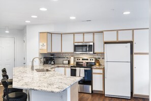 The airy kitchen offers ample space & all the comforts of home