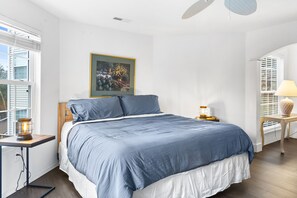 The primary king suite boasts a private ensuite, Smart TV, & balcony access