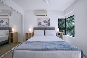 The primary bedroom has a charming leafy outlook and comes with a plush queen-sized bed and ensuite bathroom.
