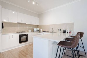 The kitchen is designed around a central island, with plenty of space to prepare meals or take things slow up at the breakfast bar.
 
