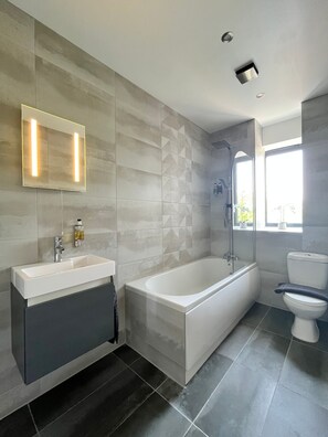 Luxury bathroom with large rainfall shower and pure Egyptian cotton towels.