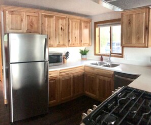 View of kitchen with stainless steel appliances.