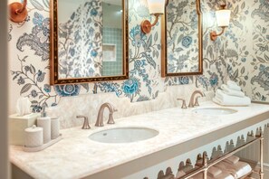 Feel pampered in a light-filled bath where elegant details and playful prints create a serene sanctuary.
