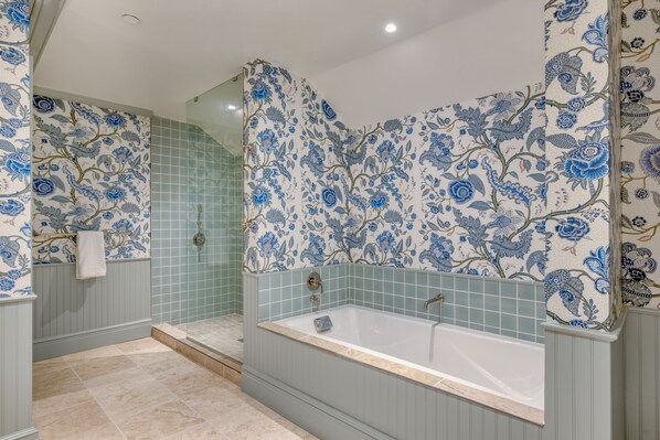 Soothing tones and floral walls set the scene for a long soak or a refreshing rinse in this spa-like sanctuary.